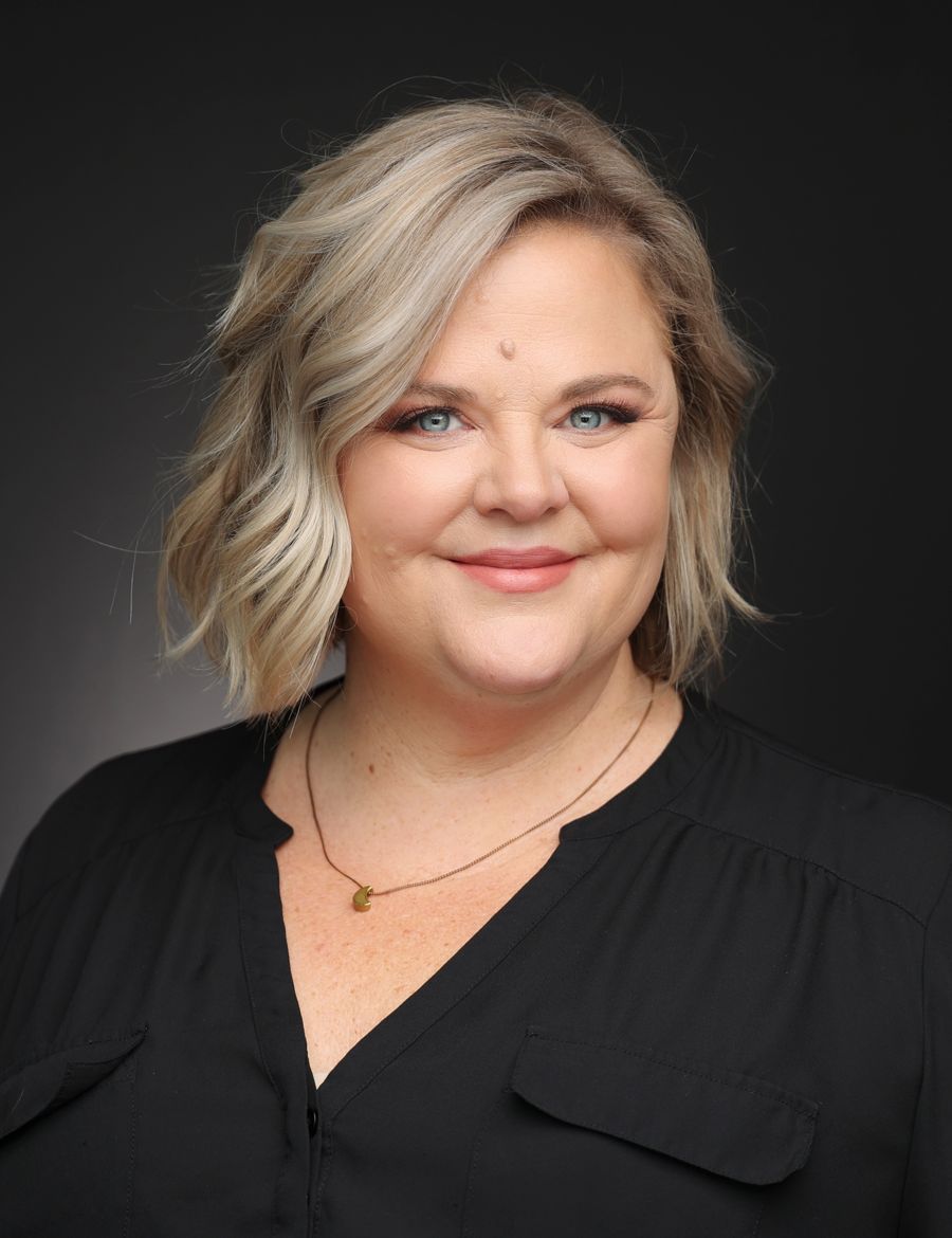 Headshot of a woman with short blonde hair